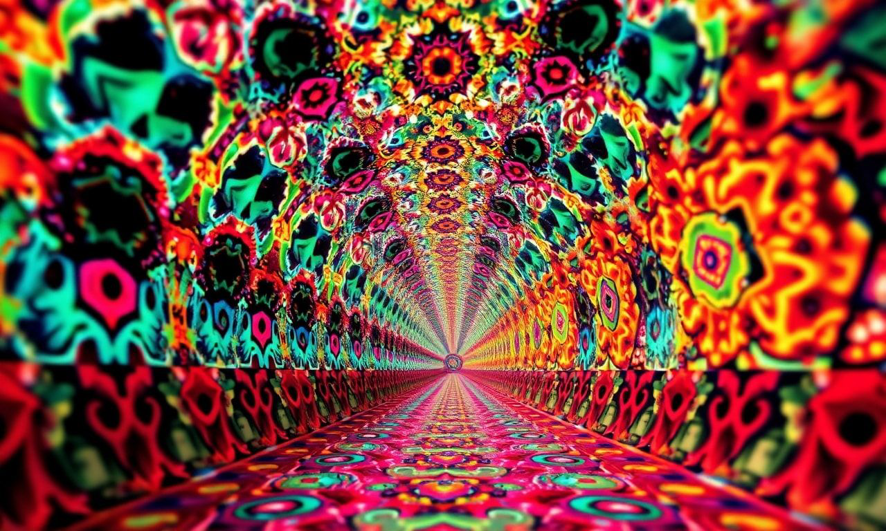 A surreal, kaleidoscopic tunnel of fractal patterns and vibrant hues, stretching infinitely into the distance, bathed in dramatic studio lighting with sharp focus on the foreground, creating a mesm...